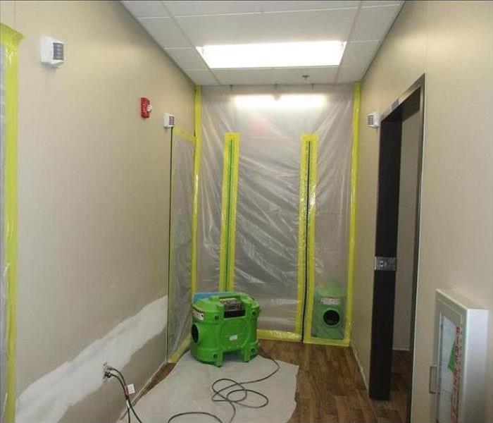 room with plastic barrier taped up